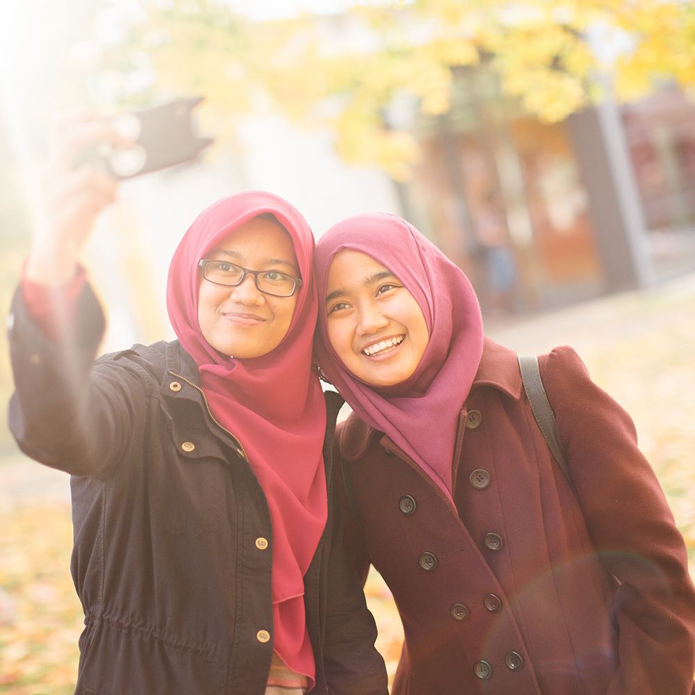 Two students taking a selfie with a mobile phone -essex